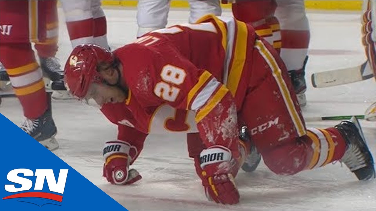 Elias Lindholm Elbows Darren Helm, Who Retaliates With A Two-Handed Slash